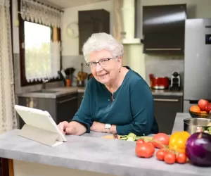 Happy,Senior,Active,Woman,Cooking,At,Home,In,Modern,Kitchen